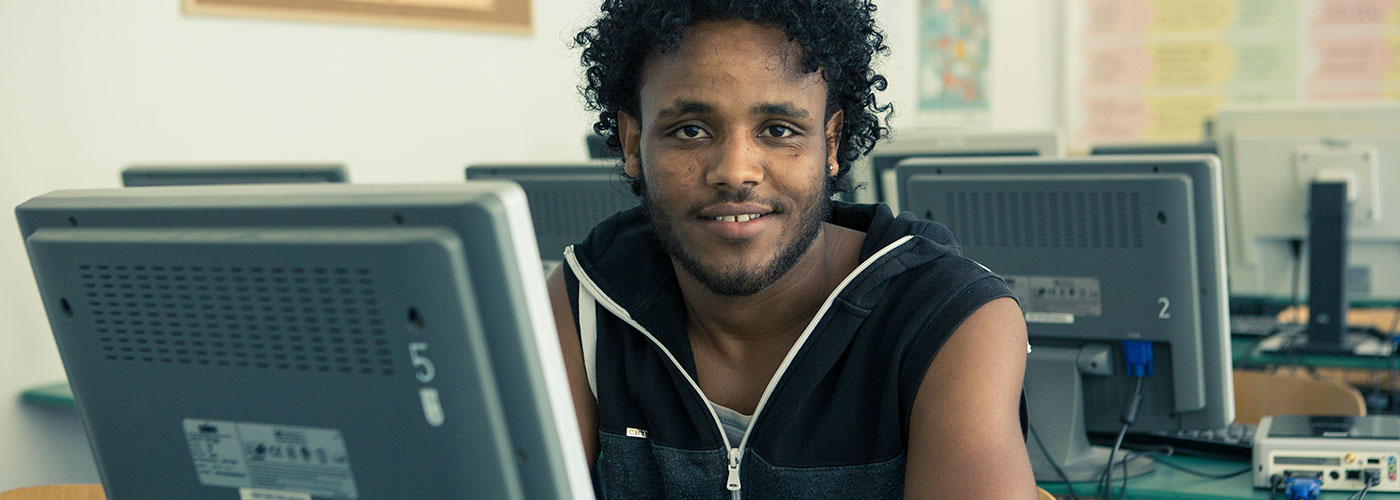 Portrait: Tsegazgi Berhe at a computer.