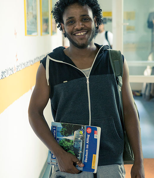 Tsegazgi Berhe is holding the book “Everyday German” in his hand.